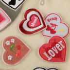 Y2K lettering heart embroidered stick-on patches displayed on table
