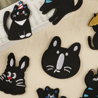 multiple funny black cat embroidered stick-on patches flat lay on table showing different designs