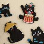 funny black cat embroidered stick-on patch flat lay on table