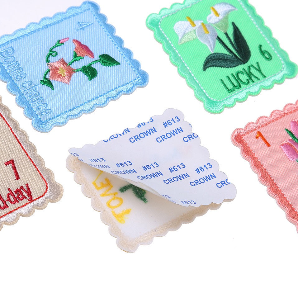 peel-and-stick backing of floral postage stamp embroidered patch