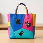 three black cat patches with large yellow eyes in sitting peeking and surprised poses on a bold color-block bag