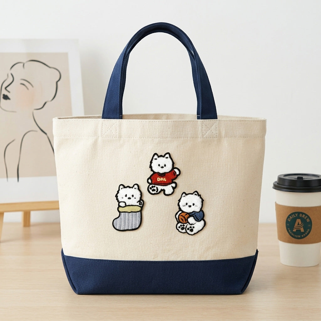 fluffy white westie in christmas stocking sweater and scarf stick-on patches decorating a cream and navy canvas handbag