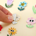 peel-and-stick backing of googly eyes floral embroidered patch
