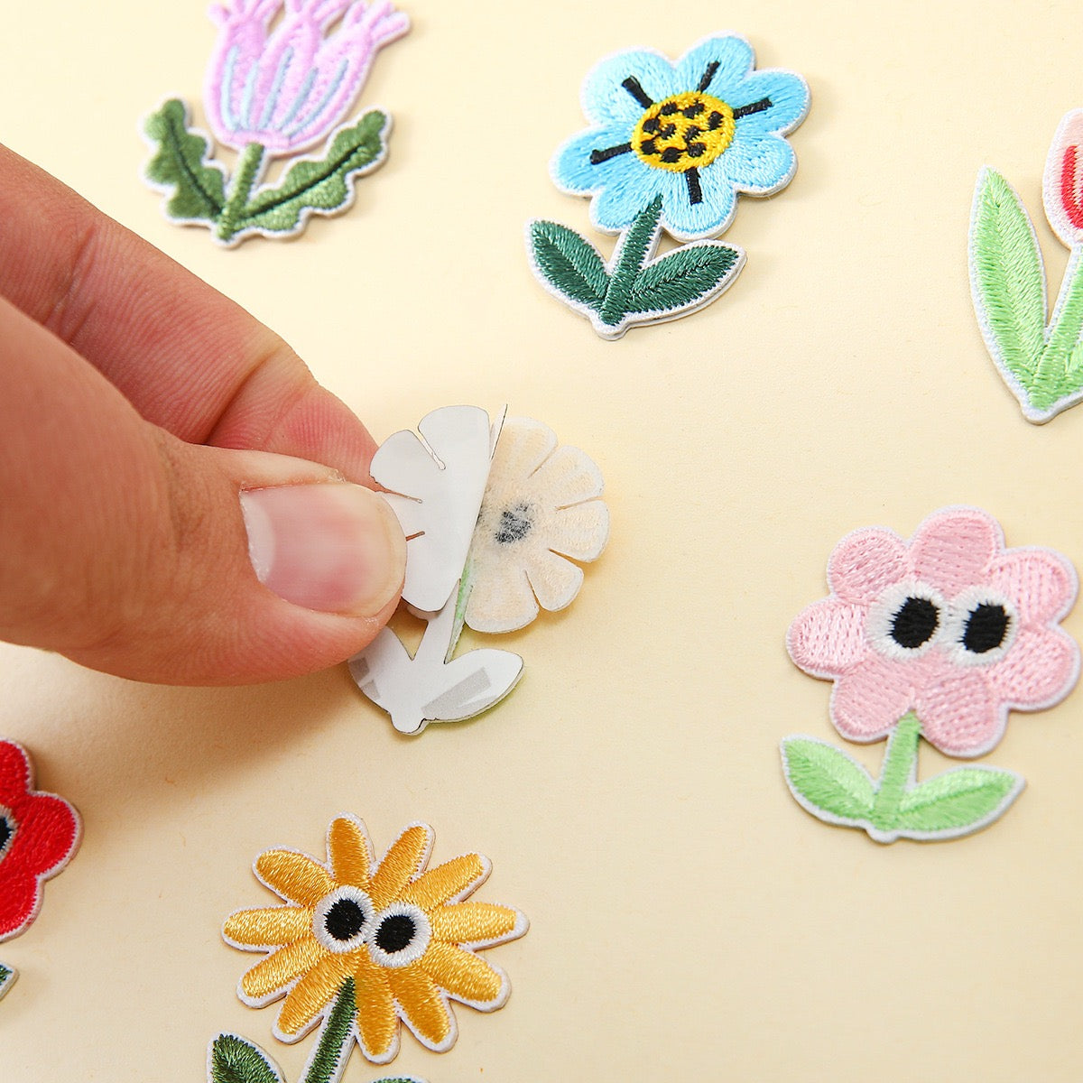 peel-and-stick backing of googly eyes floral embroidered patch