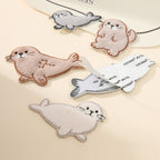 peel-and-stick backing of fluffy harp seal embroidered patch