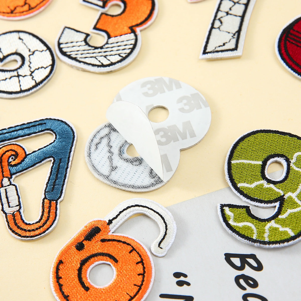 peel-and-stick backing of outdoor abstract numeric embroidered patch