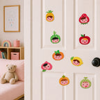 cute girl faces in pineapple strawberry watermelon apple orange lemon peach tangerine and melon fruit head patches on a white bedroom door