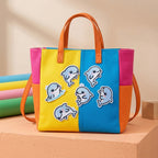 kawaii dolphin embroidered stick-on patches on a colorful color-block canvas tote bag