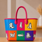 kawaii black and white cat stick-on patches in various poses decorating a vibrant color-block leather handbag