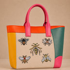 realistic bumblebee wasp and honeybee specimen stick-on patches decorating a pink and orange color-block leather handbag