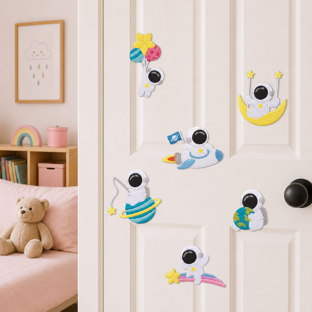 astronaut floating with balloons riding rocket sitting on moon hugging earth and lying on rainbow stick-on patches on a white bedroom door