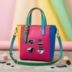 cat in boba cup coffee cup and teacup embroidered patches on a bold color-block tote