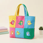 five purr-saurus cat patches in pink green yellow orange and blue dino costumes on a multicolor canvas bag