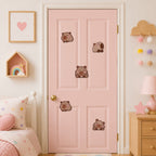 cute chubby capybara with sleepy eyes pink blush sitting lying and back view stick-on patches scattered on a pink door in a pastel bedroom