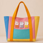 orange gray and yellow cat paw stick-on patches decorating a bright color-block canvas tote