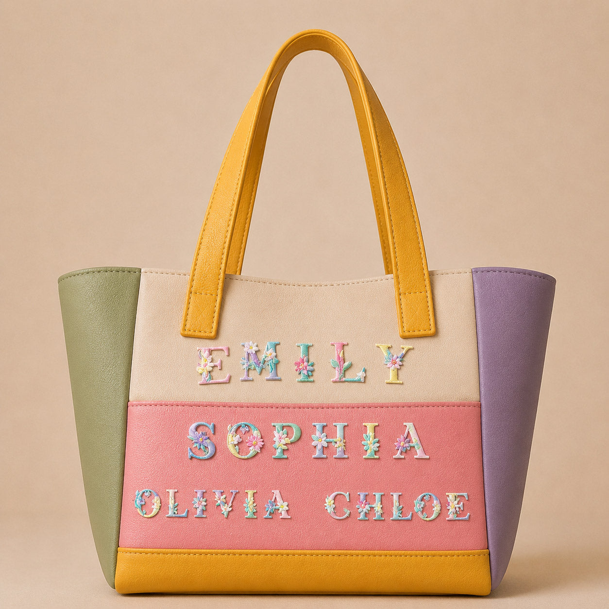 floral alphabet embroidered patches spelling names on a pastel color-block leather tote bag