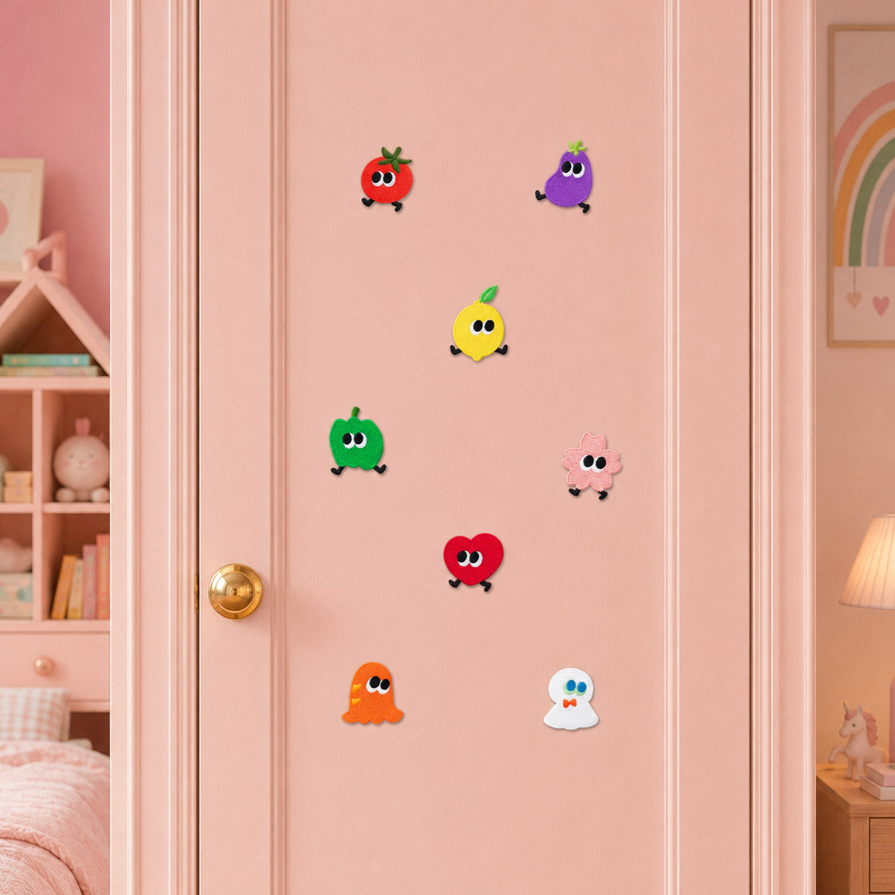 eight walking fruit veggie and ghost embroidered patches with tomato eggplant lemon apple heart and ghost stuck on a pink wardrobe door