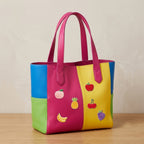 six fruit patches with peach pineapple banana apple cherry and grape on a bold multicolor leather handbag