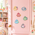 six kawaii chubby baby bottle elf embroidered patches in bunny astronaut dinosaur and elephant costumes stuck on a pink bedroom door