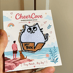 animated hand holding packaged quirky animals in boxes embroidered patches showing two styles and detailed embroidery texture