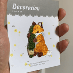 animated hand holding packaged kawaii cute fox embroidered patches showing three styles and detailed embroidery texture
