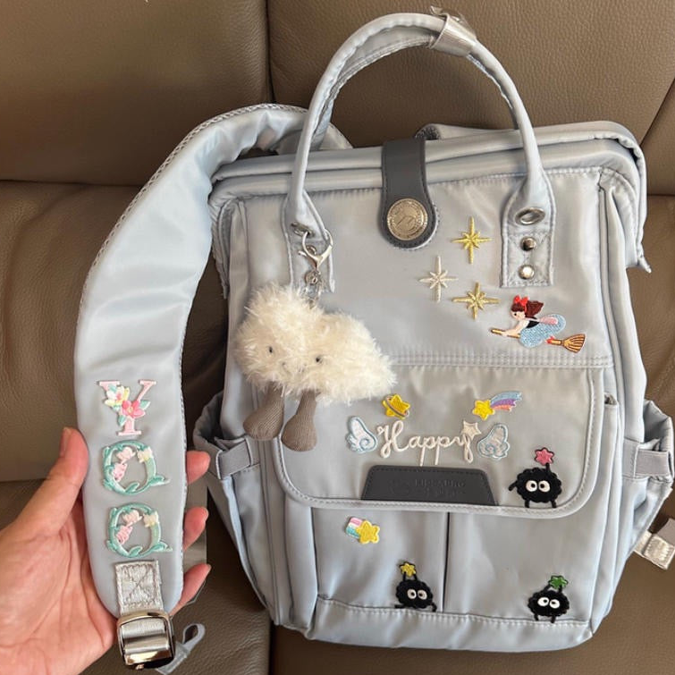 elegant floral alphabet embroidered stick-on patch on a backpack